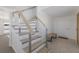 Stylish staircase with light wood and cable railing leading to the upper level at 303 65Th St # A, Holmes Beach, FL 34217
