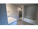 Modern bathroom featuring a soaking tub, walk-in shower, and neutral paint at 3325 Stockton Ave, North Port, FL 34286
