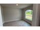 This bedroom features a large arched window and wood-look tile flooring at 3325 Stockton Ave, North Port, FL 34286