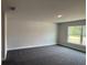 Bedroom featuring neutral paint, carpeting, and base molding plus a large window at 3325 Stockton Ave, North Port, FL 34286