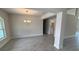 Dining Room with modern chandelier and lots of light with view into kitchen area at 3325 Stockton Ave, North Port, FL 34286
