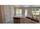 Bright kitchen featuring an island with sink and stainless steel dishwasher at 3325 Stockton Ave, North Port, FL 34286