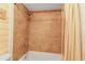 Updated bathroom with beige tile, shower/tub combo and a linen curtain at 3420 Wild Oak Bay Blvd # 118, Bradenton, FL 34210