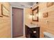 Bathroom with wood-paneled walls, a vanity and a toilet at 3420 Wild Oak Bay Blvd # 118, Bradenton, FL 34210