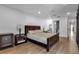 Main bedroom with hardwood floors, ceiling fan, and ensuite bathroom at 3420 Wild Oak Bay Blvd # 118, Bradenton, FL 34210