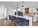 Modern kitchen with white cabinets, white countertops and blue woven barstools at 3420 Wild Oak Bay Blvd # 118, Bradenton, FL 34210