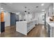 Modern kitchen with white cabinets, large island, and sliding barn door at 3420 Wild Oak Bay Blvd # 118, Bradenton, FL 34210