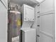 Compact laundry room with stackable washer and dryer, and water heater at 3420 Wild Oak Bay Blvd # 118, Bradenton, FL 34210