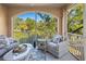 Relaxing screened balcony with wicker furniture and tranquil view at 4102 Central Sarasota Pkwy # 924, Sarasota, FL 34238