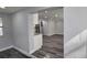 Bright and airy living room with gray walls and vinyl flooring, open to the kitchen at 4210 E Paris St, Tampa, FL 33610