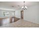 Dining room with wood-look floors and access to kitchen at 4301 Teakwood Cir, Bradenton, FL 34208