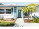 Front entrance with teal door and walkway, surrounded by tropical plants at 4301 Teakwood Cir, Bradenton, FL 34208