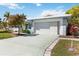 Front view of the house showcasing the garage and landscaping at 4301 Teakwood Cir, Bradenton, FL 34208