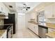 Kitchen with granite countertops, white cabinets, and stainless steel appliances at 4301 Teakwood Cir, Bradenton, FL 34208