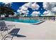 Community pool with plenty of lounge chairs for relaxing at 4301 Teakwood Cir, Bradenton, FL 34208