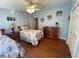 Spacious bedroom featuring two twin beds, dresser, and wood floors at 4851 W Gandy Blvd # 5Pa, Tampa, FL 33611
