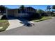 Mobile home with a covered carport and well-kept lawn at 4851 W Gandy Blvd # 5Pa, Tampa, FL 33611
