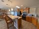 Spacious kitchen with light wood cabinets and an island at 4851 W Gandy Blvd # 5Pa, Tampa, FL 33611