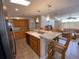 Open kitchen with island, wood cabinets, and stainless steel appliances at 4851 W Gandy Blvd # 5Pa, Tampa, FL 33611