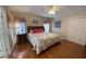 Bright main bedroom with wood floors, large bed, and walk-in closet at 4851 W Gandy Blvd # 5Pa, Tampa, FL 33611