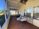 Covered screened porch with ceiling fan and outdoor furniture at 4851 W Gandy Blvd # 5Pa, Tampa, FL 33611