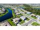 Aerial view of a neighborhood showcasing a community of homes near a serene lake and lush greenery at 4906 Lighthouse Bay Ln, Bradenton, FL 34211