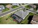 Aerial view of a home showcasing a screened pool enclosure, well-manicured lawn, and a newly installed roof at 4906 Lighthouse Bay Ln, Bradenton, FL 34211