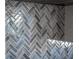 Detailed view of the elegant backsplash with herringbone pattern in the kitchen at 4906 Lighthouse Bay Ln, Bradenton, FL 34211