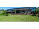 Lush backyard featuring well-maintained landscaping, manicured green lawn, and screened in pool area at 4906 Lighthouse Bay Ln, Bradenton, FL 34211
