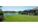 The lush backyard offers a serene view of the lake and features a screened-in pool area at 4906 Lighthouse Bay Ln, Bradenton, FL 34211