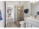 Bathroom featuring a tiled shower, a vanity with framed mirror, and wood look flooring at 4906 Lighthouse Bay Ln, Bradenton, FL 34211