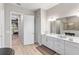 Bathroom features double sinks, a large mirror, and a view into the tiled shower and bedroom beyond at 4906 Lighthouse Bay Ln, Bradenton, FL 34211