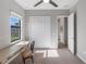 This bedroom offers a ceiling fan, a built in desk, and closet for storage at 4906 Lighthouse Bay Ln, Bradenton, FL 34211