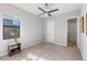 Bright bedroom features neutral walls, carpet flooring, a ceiling fan, and a side table at 4906 Lighthouse Bay Ln, Bradenton, FL 34211