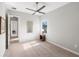 Bedroom features a ceiling fan, neutral carpeting, natural light and view to hallway at 4906 Lighthouse Bay Ln, Bradenton, FL 34211