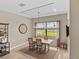 Cozy dining room with wood table, large window view and unique ceiling detail at 4906 Lighthouse Bay Ln, Bradenton, FL 34211