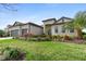 Beautiful single-story home featuring a well-manicured lawn and tropical landscaping at 4906 Lighthouse Bay Ln, Bradenton, FL 34211
