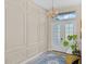 Elegant foyer featuring a decorative wall, chandelier, and double front doors at 4906 Lighthouse Bay Ln, Bradenton, FL 34211