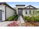 Charming home entrance with well-maintained landscaping and a brick pathway at 4906 Lighthouse Bay Ln, Bradenton, FL 34211