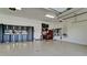 Spacious garage featuring epoxy floor, ample storage cabinets, and organized tool racks at 4906 Lighthouse Bay Ln, Bradenton, FL 34211