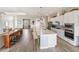 Open kitchen with white cabinets, stainless steel appliances, and an expansive island with bar seating at 4906 Lighthouse Bay Ln, Bradenton, FL 34211