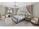 Spacious main bedroom with sitting area, tray ceiling, and sliding doors to outdoor space at 4906 Lighthouse Bay Ln, Bradenton, FL 34211