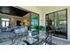 Comfortable outdoor patio with a glass table and seating with view to the living room at 4906 Lighthouse Bay Ln, Bradenton, FL 34211