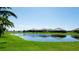A calm pond and green lawns define this home's backyard and community at 4906 Lighthouse Bay Ln, Bradenton, FL 34211