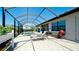 A screened-in lanai features a pool, lounge chairs, and a barbeque area, perfect for outdoor entertaining at 4906 Lighthouse Bay Ln, Bradenton, FL 34211