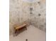 Tiled shower features a built-in shelf, showerhead, and stylish, comfortable wooden bench at 4906 Lighthouse Bay Ln, Bradenton, FL 34211