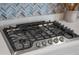 Close-up of gas stovetop with stainless steel knobs, installed in a kitchen setting at 4906 Lighthouse Bay Ln, Bradenton, FL 34211