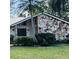 Close-up of a beautiful home featuring an eye-catching stone facade, a black front door, and well-maintained landscaping at 5358 Everwood Run, Sarasota, FL 34235