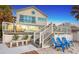 Backyard with deck, patio furniture, white stairs, and white picket fence at 681 Casey Key Rd, Nokomis, FL 34275