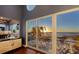 Beach view off of balcony through sliding glass doors, sunset over the ocean at 681 Casey Key Rd, Nokomis, FL 34275